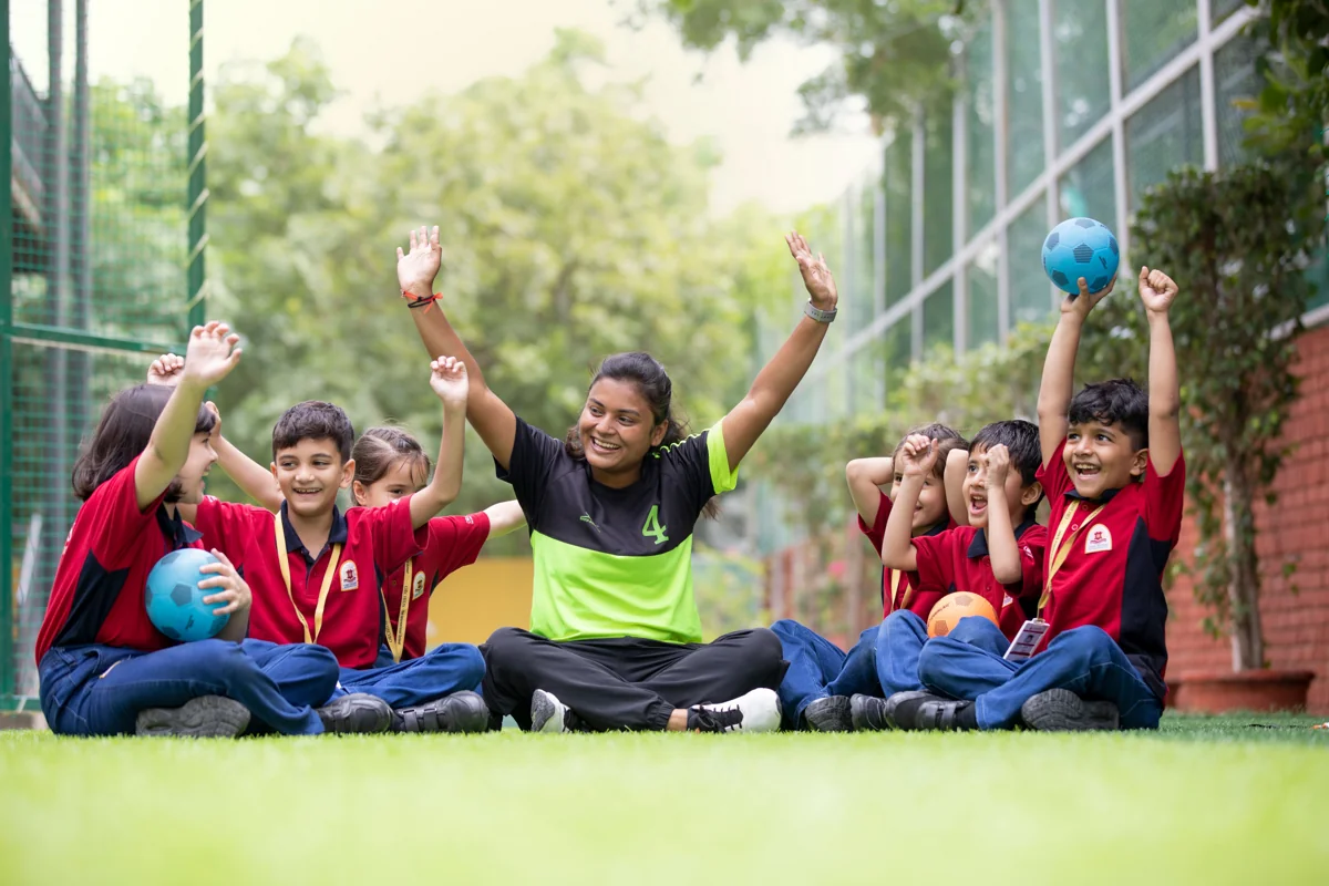 Schoolchildren and their teacher enjoying an outdoor activity in Bengaluru